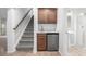 Basement features a bar area with custom cabinets, stainless steel appliances, and under-stair storage at 1041 Riddlewood Rd, Highlands Ranch, CO 80129