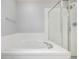 Modern bathroom with tiled tub and shower, features sleek glass and chrome fixtures at 1041 Riddlewood Rd, Highlands Ranch, CO 80129