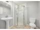 Bathroom showcases a glass-enclosed shower, pedestal sink, and a modern toilet at 1041 Riddlewood Rd, Highlands Ranch, CO 80129