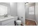 Bathroom features a modern vanity, sleek fixtures, and a window for natural light at 1041 Riddlewood Rd, Highlands Ranch, CO 80129