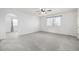 Bright bedroom with gray carpet, natural lighting, and a ceiling fan at 1041 Riddlewood Rd, Highlands Ranch, CO 80129