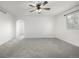 Spacious bedroom with gray carpet, natural lighting, and a ceiling fan at 1041 Riddlewood Rd, Highlands Ranch, CO 80129