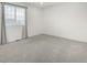 Minimalist bedroom with natural light from the window and plush carpeting at 1041 Riddlewood Rd, Highlands Ranch, CO 80129
