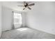 This bright bedroom features neutral carpet, a ceiling fan and large windows for lots of natural light at 1041 Riddlewood Rd, Highlands Ranch, CO 80129