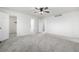 Spacious bedroom with neutral carpet, ceiling fan, and multiple closets for ample storage at 1041 Riddlewood Rd, Highlands Ranch, CO 80129