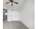 A bedroom with neutral walls, a ceiling fan, and a closet with double doors at 1041 Riddlewood Rd, Highlands Ranch, CO 80129