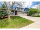 Inviting two-story home with well-maintained lawn and three-car attached garage at 1041 Riddlewood Rd, Highlands Ranch, CO 80129