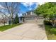 Two-story home featuring a spacious driveway and attached three car garage at 1041 Riddlewood Rd, Highlands Ranch, CO 80129