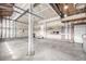 This large unfinished garage has concrete floors, exposed beams, and room for storage at 1041 Riddlewood Rd, Highlands Ranch, CO 80129