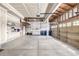 Spacious two car garage with workbench, shelving, and ample room for storage, and a sealed concrete floor at 1041 Riddlewood Rd, Highlands Ranch, CO 80129