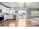 Modern kitchen with white cabinets, stainless steel appliances, and hardwood floors at 1041 Riddlewood Rd, Highlands Ranch, CO 80129