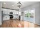 Well-lit kitchen with white cabinetry, stainless steel appliances, and a sliding glass door to deck at 1041 Riddlewood Rd, Highlands Ranch, CO 80129