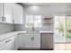 Kitchen features white cabinets, modern countertops, stainless steel appliances, and hardwood floors at 1041 Riddlewood Rd, Highlands Ranch, CO 80129