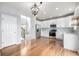 Well-lit kitchen boasting stainless steel appliances, white cabinets, and hardwood flooring at 1041 Riddlewood Rd, Highlands Ranch, CO 80129