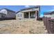 Back of house has covered patio, neutral siding, and unfinished yard in a residential neighborhood at 188 S Waterloo St, Aurora, CO 80018
