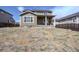 Back exterior of a home with a covered patio and an unfinished yard under a blue sky at 188 S Waterloo St, Aurora, CO 80018