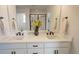Bathroom featuring double vanity with undermount sinks, white cabinets and black hardware at 188 S Waterloo St, Aurora, CO 80018