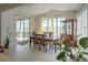 Bright dining room with a spacious table, large windows, and sliding glass doors to the patio at 188 S Waterloo St, Aurora, CO 80018