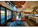 Elegant dining area with a long wooden table, modern chandelier, and large windows, ideal for gatherings at 188 S Waterloo St, Aurora, CO 80018