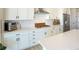 Bright kitchen featuring white cabinetry, stainless steel appliances, and a subway tile backsplash at 188 S Waterloo St, Aurora, CO 80018