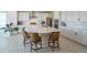 Spacious kitchen featuring a large island with barstool seating, white cabinets, and stainless appliances at 188 S Waterloo St, Aurora, CO 80018
