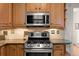 Stainless steel gas range and microwave in updated kitchen at 3050 N Gaylord St, Denver, CO 80205