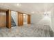 Open basement with carpet and access to the upper floor at 6300 W Mansfield Ave # 61, Denver, CO 80235