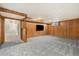 Finished basement with carpet, wood paneled walls, and a TV at 6300 W Mansfield Ave # 61, Denver, CO 80235