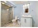 Bright bathroom with glass enclosed shower, marble countertop, and modern toilet at 6300 W Mansfield Ave # 61, Denver, CO 80235