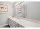 Well-lit bathroom with a wide mirror, vanity, and light-colored walls, creating a clean and modern feel at 6300 W Mansfield Ave # 61, Denver, CO 80235