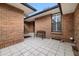Charming brick courtyard with tiled floor and a comfortable bench, ideal for outdoor relaxation at 6300 W Mansfield Ave # 61, Denver, CO 80235