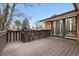 Exterior shot of the wood deck and sliding glass doors to the home at 6300 W Mansfield Ave # 61, Denver, CO 80235