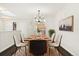 Elegant dining room with modern chandelier, stylish decor, and a view of the adjacent kitchen at 6300 W Mansfield Ave # 61, Denver, CO 80235