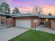 Charming single-story brick home with a well-maintained lawn and attached garage, offering classic curb appeal at 6300 W Mansfield Ave # 61, Denver, CO 80235