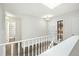 Hallway featuring white railing, natural light, a skylight, and multiple doors at 6300 W Mansfield Ave # 61, Denver, CO 80235