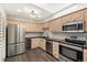 Well-equipped kitchen featuring stainless steel appliances, custom cabinets, and sleek countertops at 6300 W Mansfield Ave # 61, Denver, CO 80235