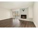 Bright living room featuring a brick fireplace, sliding glass doors, and hardwood floors at 6300 W Mansfield Ave # 61, Denver, CO 80235