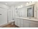 Bright bathroom featuring double vanity, quartz countertop, and a glass-enclosed shower at 24739 E 39Th Ave, Aurora, CO 80019