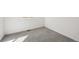 Angle view of a bedroom showing the neutral walls, gray carpeting, and base molding at 24739 E 39Th Ave, Aurora, CO 80019
