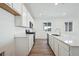 Modern kitchen with white cabinets and a bright, open layout for entertaining at 24739 E 39Th Ave, Aurora, CO 80019
