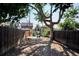 Large backyard with a tree, partial fencing, and an in-ground sprinkler system with a view of neighboring houses at 2731 W 32Nd Ave, Denver, CO 80211