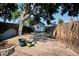 Spacious backyard featuring partial fencing, a shed, mature trees, and decorative flower pots on a patio at 2731 W 32Nd Ave, Denver, CO 80211