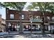 Commercial building featuring a brick exterior, large windows, street-side signage, and trees on a city street at 2731 W 32Nd Ave, Denver, CO 80211