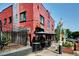 Commercial building featuring a red brick exterior, large windows, outdoor seating, and street-side signage at 2731 W 32Nd Ave, Denver, CO 80211