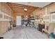 A spacious garage interior with a concrete floor, exposed wooden rafters and shelving for storage at 2731 W 32Nd Ave, Denver, CO 80211