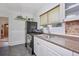 Well-lit kitchen featuring a stainless steel range and ample counter space at 2731 W 32Nd Ave, Denver, CO 80211