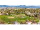 Scenic aerial view featuring a lush green park with mountain views and beautiful homes nearby at 11525 Eaton Ct, Westminster, CO 80020