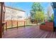 Inviting backyard with a wooden deck, planters, lawn, and privacy fence, perfect for outdoor relaxation at 11525 Eaton Ct, Westminster, CO 80020