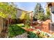Backyard with a newly installed stained wooden deck and a small lawn at 11525 Eaton Ct, Westminster, CO 80020
