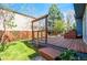 Backyard with a newly installed stained wooden deck and privacy fence at 11525 Eaton Ct, Westminster, CO 80020
